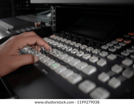 closeup hands on the switcher buttons,video switcher of Television Broadcast.