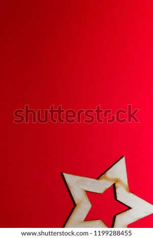 Christmas wooden toy of stars on a red background