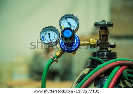 Oxygen regulator, Pressure gauge on oxygen cylinder for  cutting of steel with acetylene and oxygen.
