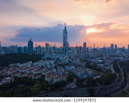 Sunset behind the skyscraper which is the tallest building in Nanjing city taken with a drone in the air.