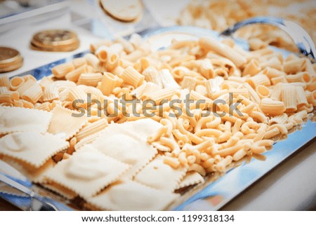various samples of raw pasta on a tray, close up