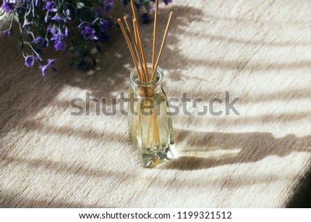 Aromatic reed air freshener.Handmade reed freshener on cozy lavender background.aroma oil bottle. Royalty-Free Stock Photo #1199321512