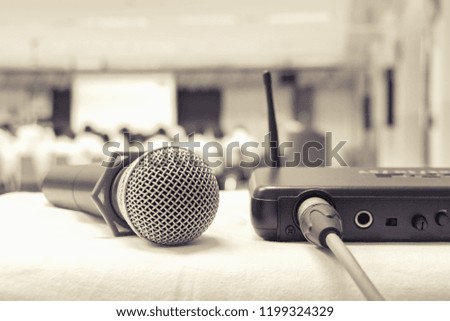 Close up old microphone wireless with box signal on the white table in business conference interior seminar meeting room and Background blur. Effects toning ancient