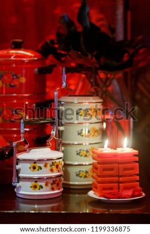 Beautiful oriental style wedding reception table setting with traditional food tray and Chinese wedding symbol "Double Happiness" shape candle.
