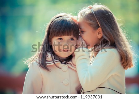 Happy little girlfriends in park Royalty-Free Stock Photo #119937031