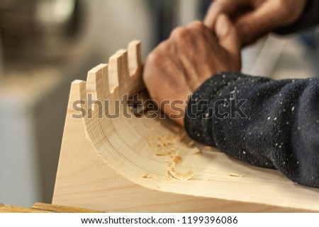 Eco friendly woodworker's shop. Details and focus on the texture of the material, saw dust, and planers or chisels, while making legs for a designer coffee table. Mastering wood with peacefullness. Royalty-Free Stock Photo #1199396086