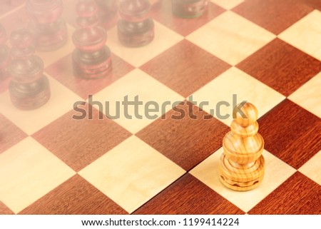 A pawn on a chessboard, a metaphor for the first step, with a background blurred for copy space