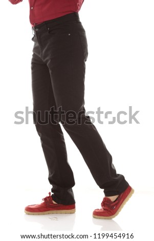 Man's leg with black denim on white background