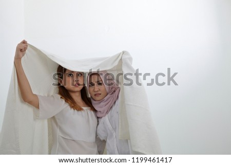 good friend sharing white blanket together