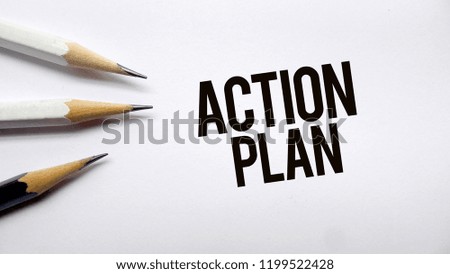 Action plan text memo written on a white background with pencils