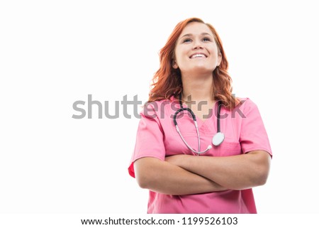 Low angle of young female doctor with stethoscope laughing with arms crossed isolated on white background with copyspace advertising area
