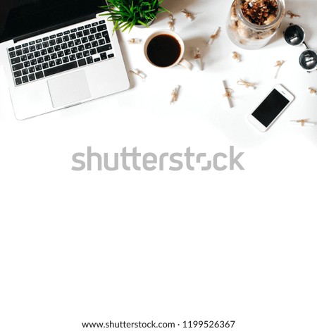 Work place in flat lay style. Cute modern white office desk table with laptop, smartphone, office plant, fortune notes, notebook, sunglasses, pen and pencil. Top view with copy space, flat lay, square
