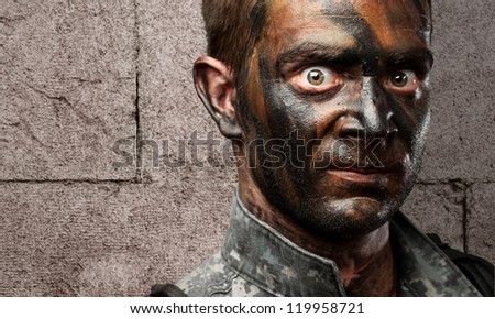 Closeup of a soldier against a grunge wall background