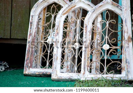 arched wooden windows at a salvage yard Royalty-Free Stock Photo #1199600011