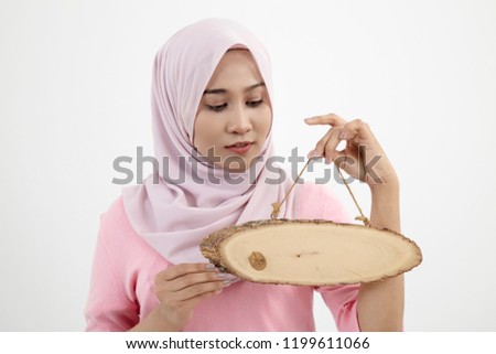 malay woman holding blank wooden signage for copy space
