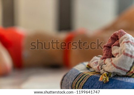 Traditional turkish bath material and girl in red bikini in background