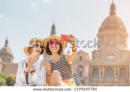 Two young happy women tourists friends travel in Barcelona, Spain