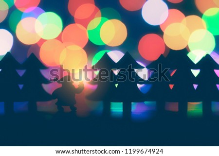 christmas closeup with stylized santa claus and pine trees on a colorful bokeh blue background
