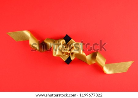 Beautiful minimalistic multi purpose composition with gift box wrapped and tied with satin ribbon. Holiday present in festive wrapping. Background, copy space, close up, top view, flat lay.
