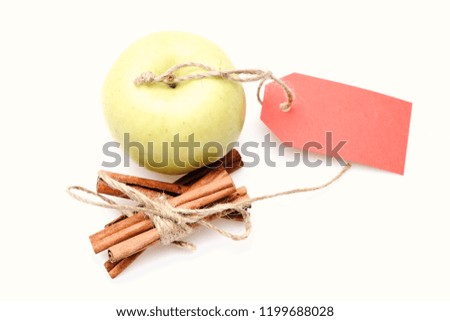 Eco shopping and perfect mix concept. Apples and tied cinnamon sticks isolated on white background. Set of fruit, cinnamon and empty red price tag, copy space. Composition of apples and spices.