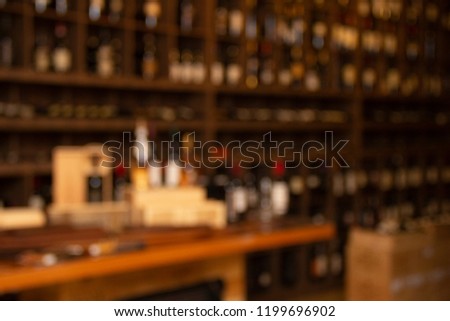 Bottles of wine on wooden shelves in winery collection
