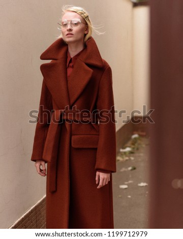 Girl model in a coat. Street style and fashion photo. Professional model.