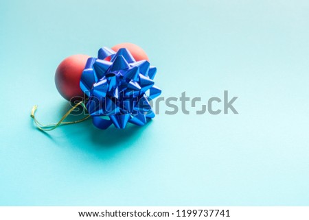 Red Christmas Balls and a blue Star over a beautiful blue background