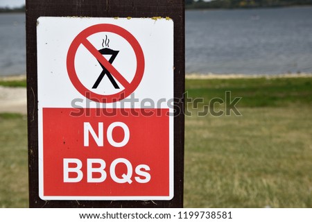 No BBQs sign white text on red background with barbecue symbol on red circle.
