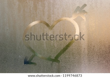 The heart is painted on the misted glass