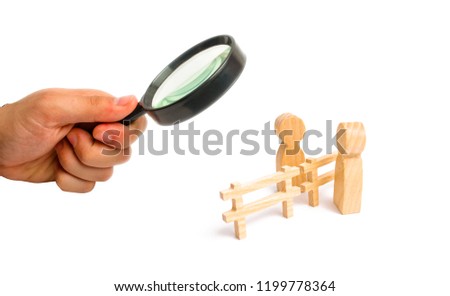Magnifying glass is looking at the wooden fence divides the two persons discussing the case. Termination and breakdown of relations, breaking ties. Contract break, conflict of interests.