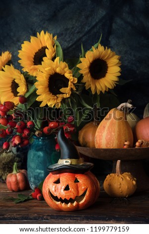 Halloween pumpkin decor with autumn flowers