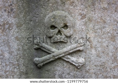 Skull and crossbones on a stone plate