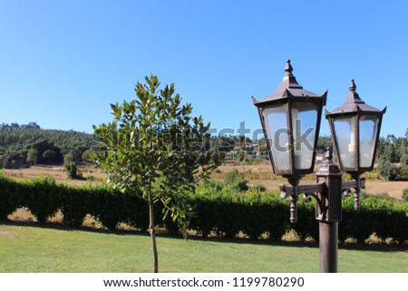 Vintage lanterns on the garden with sun light. Garden design and decoration.