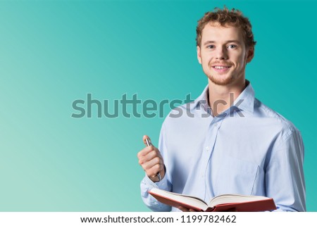 Young male teacher   standing in class