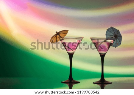 colourful cocktail on the club light background.