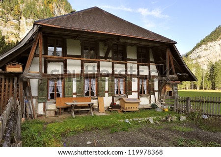 A Swiss farmhouse in the Gasteretal valley above Kandersteg, Switzerland. Space for text in the sky