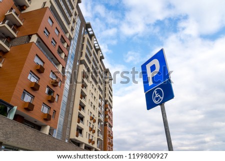 Parking zone sign in front of the residential building. Handicapped parking space.
