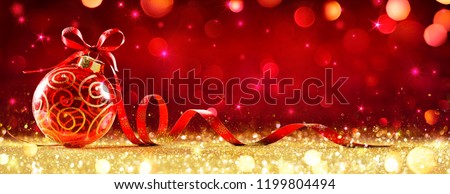 Red Christmas Sphere With Bow On Golden Glitter
