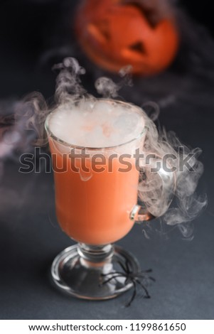 Halloween cocktail on a dark background with smoke effect
