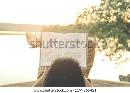 Relaxing moments, Young boy opening and reading a book. Relax time on holiday concept travel, Thailand.