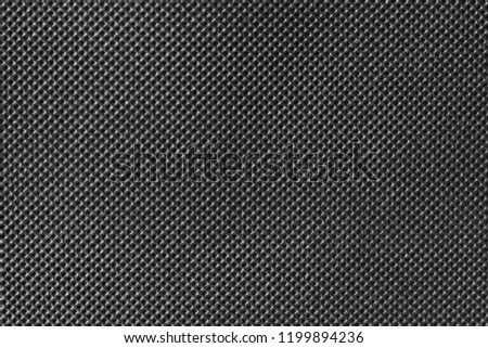 Black carbon fiber texture. Dark raw material background.