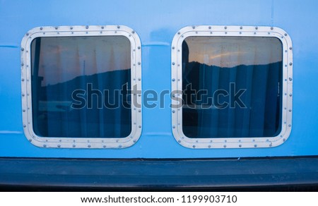 2 clear ship window with rectangle shape reflection and blue wall color in karimun jawa indonesia Royalty-Free Stock Photo #1199903710