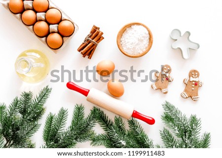Ingredients for gignerbread cookies for New Year 2019. Flour, eggs, oil, cinnamon near spruce branch and rolling pin on white background top view