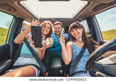 road trip group of people making selfie in the car. car travel concept