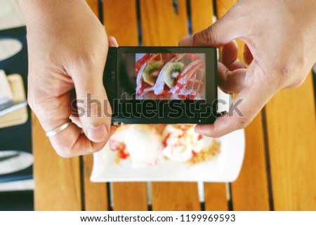 A hand held do shooting some food under his  camera, life style  concept