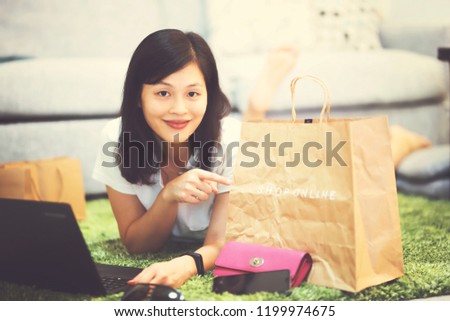 Young woman online shopping at home 