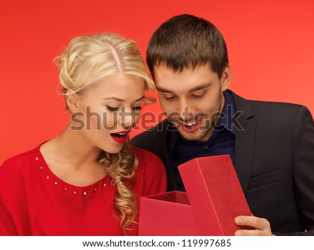 picture of man and woman looking inside the box (focus on man)