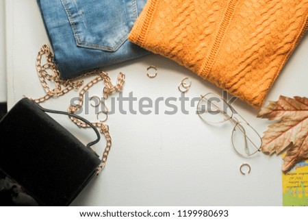 fall mockup  with sweater and jeans, autumn leaves and details Mockup with postcard and flowers and ribbon on white background. frame with copy place