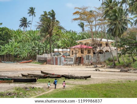 African Fishermen Village by the sea in Sao Tome and Principe near mountains like Pico Cao Grande. Travel to Sao Tome and Principe to see a beautiful paradise island in Gulf of Guinea in Africa Royalty-Free Stock Photo #1199986837