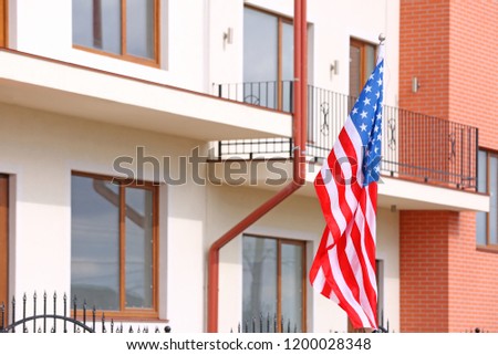 American flag near apartment building on city street